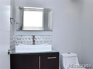 244 South Monroe Street Denver, CO 80209 - Photo 14 of 16 a bathroom with a sink a toilet and a window