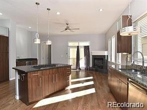 244 South Monroe Street Denver, CO 80209 - Photo 4 of 16 a kitchen with granite countertop a stove a sink and a refrigerator