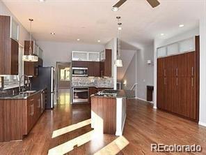 244 South Monroe Street Denver, CO 80209 - Photo 5 of 16 a kitchen with stainless steel appliances granite countertop a refrigerator stove and oven