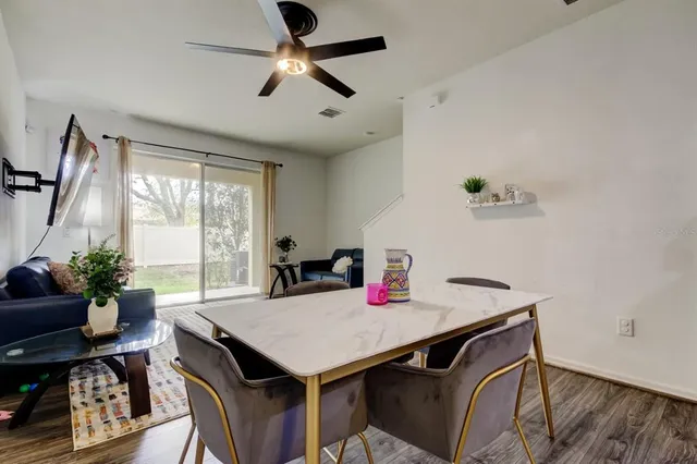 a view of a dining room with furniture window and wooden floor
