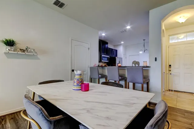 a dining room with kitchen island a table and chairs
