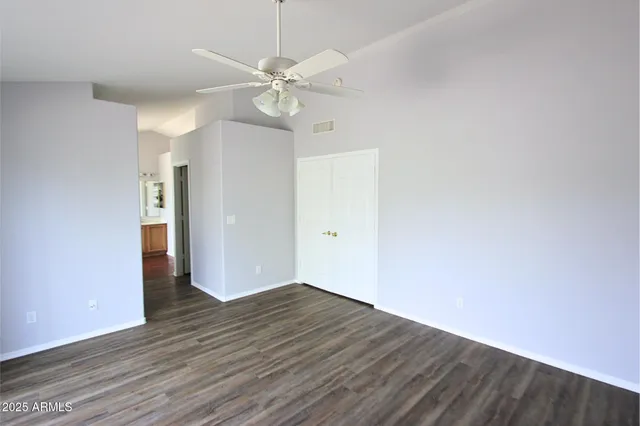 a view of an empty room with wooden floor