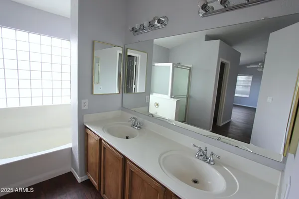 a bathroom with a tub sink and mirror