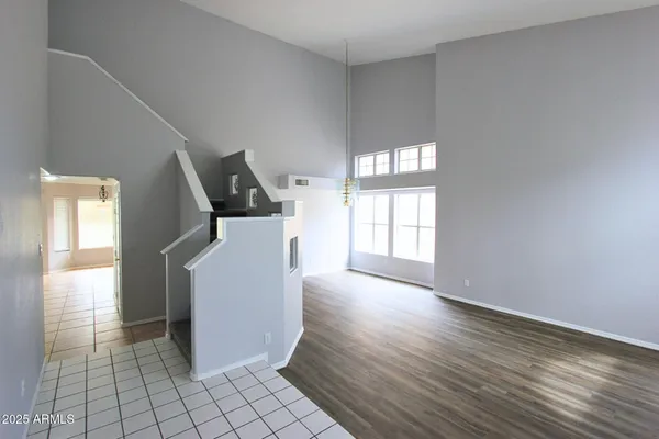 a view of a hallway with entryway and wooden floor