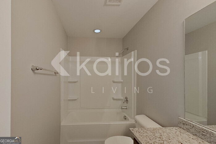 101 St Matthew Way Springfield, GA 31329 - Photo 22 of 30 a bathroom with a granite countertop bathtub shower and toilet