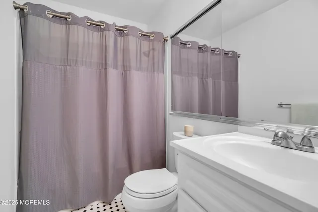 a view of a livingroom with a ceiling fan and window
