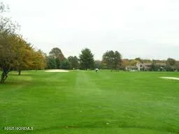 a view of two chairs and table in a backyard