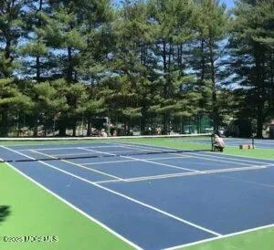 a backyard of a house with lots of green space and lake view