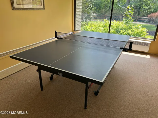 a room with pool table and flat screen tv
