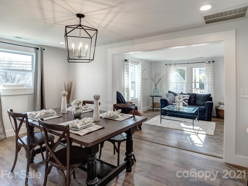 36 Center Pigeon Road Canton, NC 28716 - Photo 12 of 30 a view of a dining room with furniture a chandelier and wooden floor