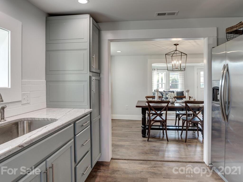 36 Center Pigeon Road Canton, NC 28716 - Photo 17 of 30 a kitchen with kitchen island a dining table chairs cabinets and stainless steel appliances