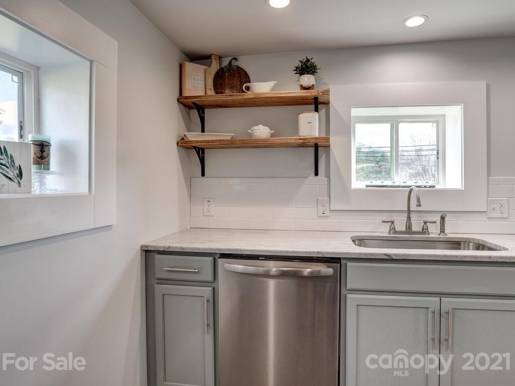 36 Center Pigeon Road Canton, NC 28716 - Photo 18 of 30 a kitchen with stainless steel appliances granite countertop a sink a stove and a microwave