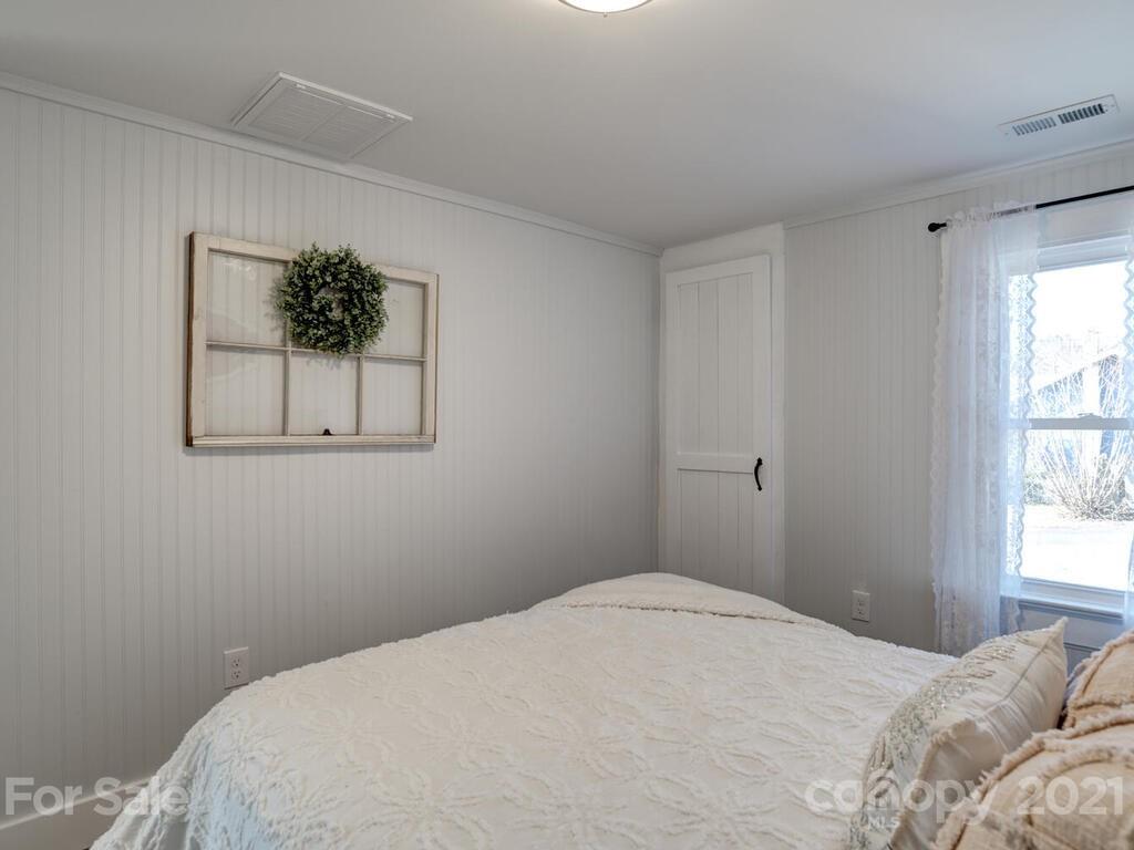36 Center Pigeon Road Canton, NC 28716 - Photo 23 of 30 a bedroom with a bed and a window