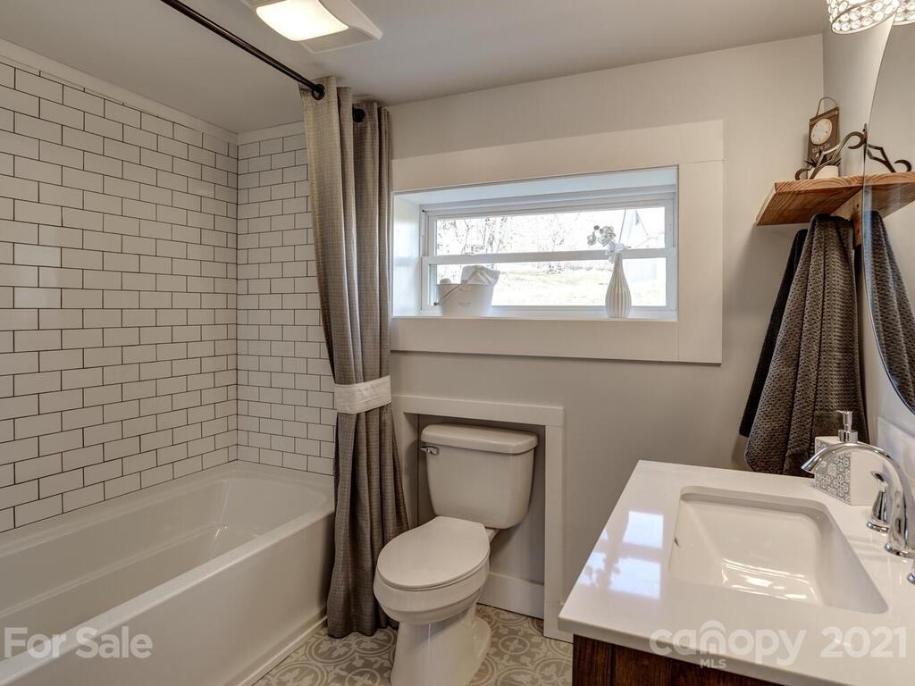 36 Center Pigeon Road Canton, NC 28716 - Photo 24 of 30 a bathroom with a sink a toilet and bathtub