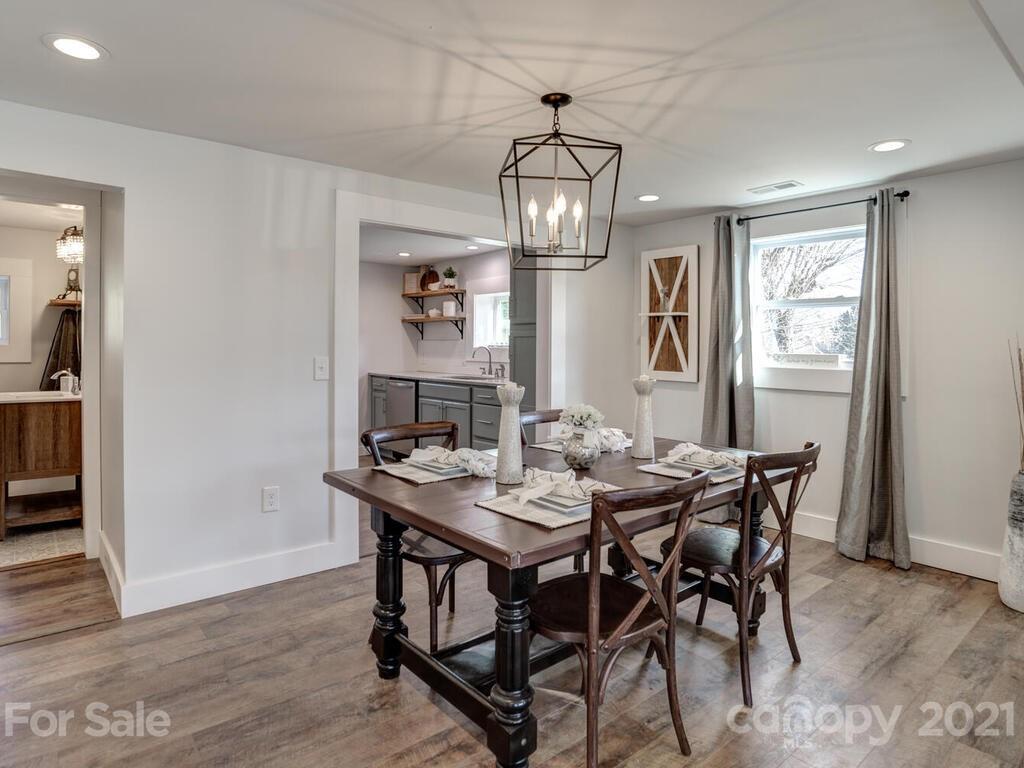 36 Center Pigeon Road Canton, NC 28716 - Photo 10 of 30 a view of a dining room with furniture a chandelier and wooden floor