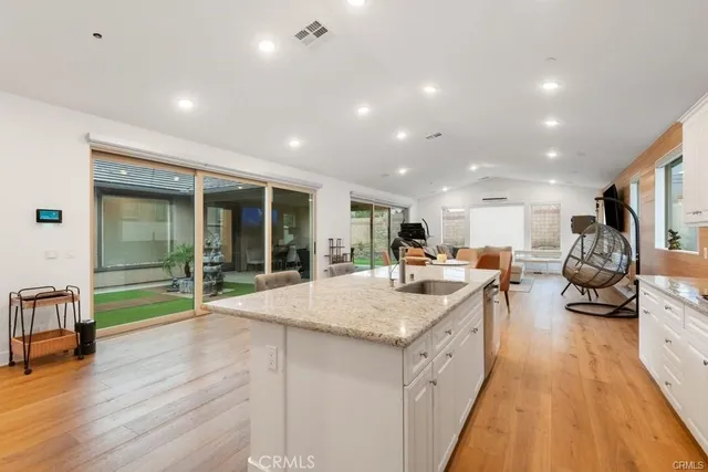 a large white kitchen with a large window