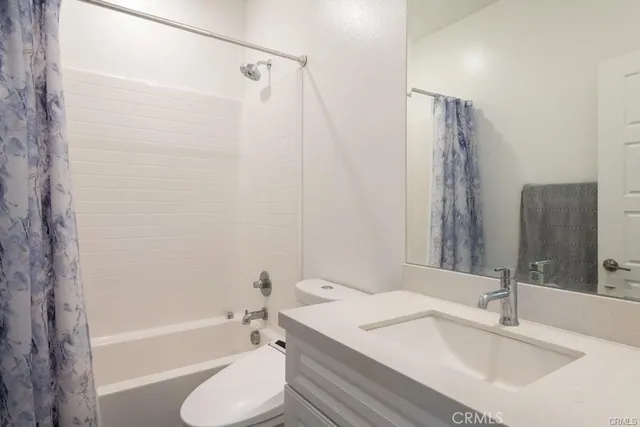 a bathroom with a sink toilet tub and shower