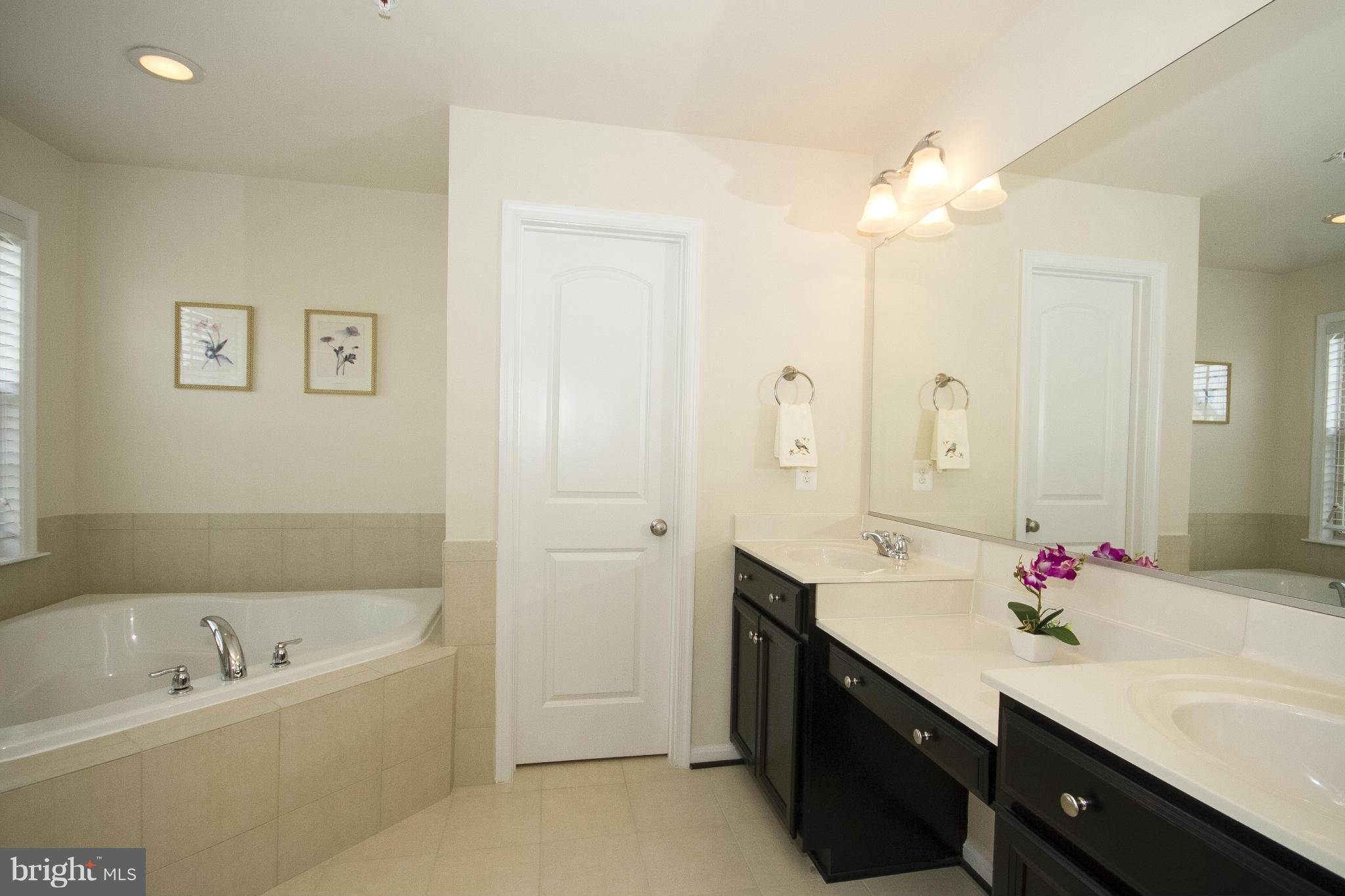 4310 Stoss Road Perry Hall, MD 21128 - Photo 13 of 22 a spacious bathroom with a tub sink and mirror
