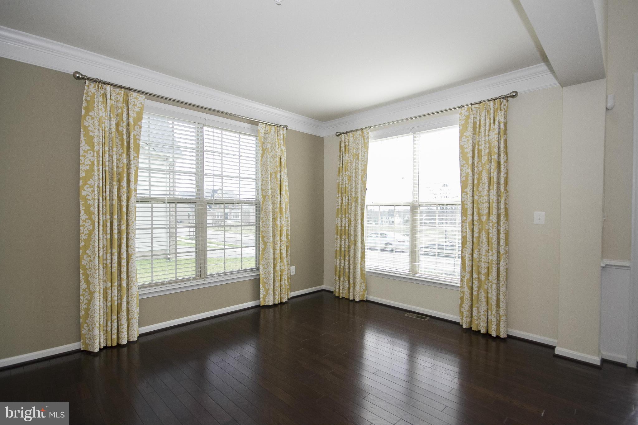 4310 Stoss Road Perry Hall, MD 21128 - Photo 3 of 22 a view of an empty room with wooden floor and a window