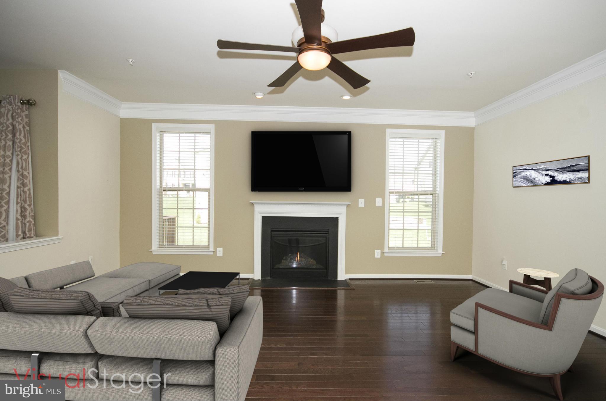 4310 Stoss Road Perry Hall, MD 21128 - Photo 8 of 22 a living room with furniture a fireplace and a flat screen tv