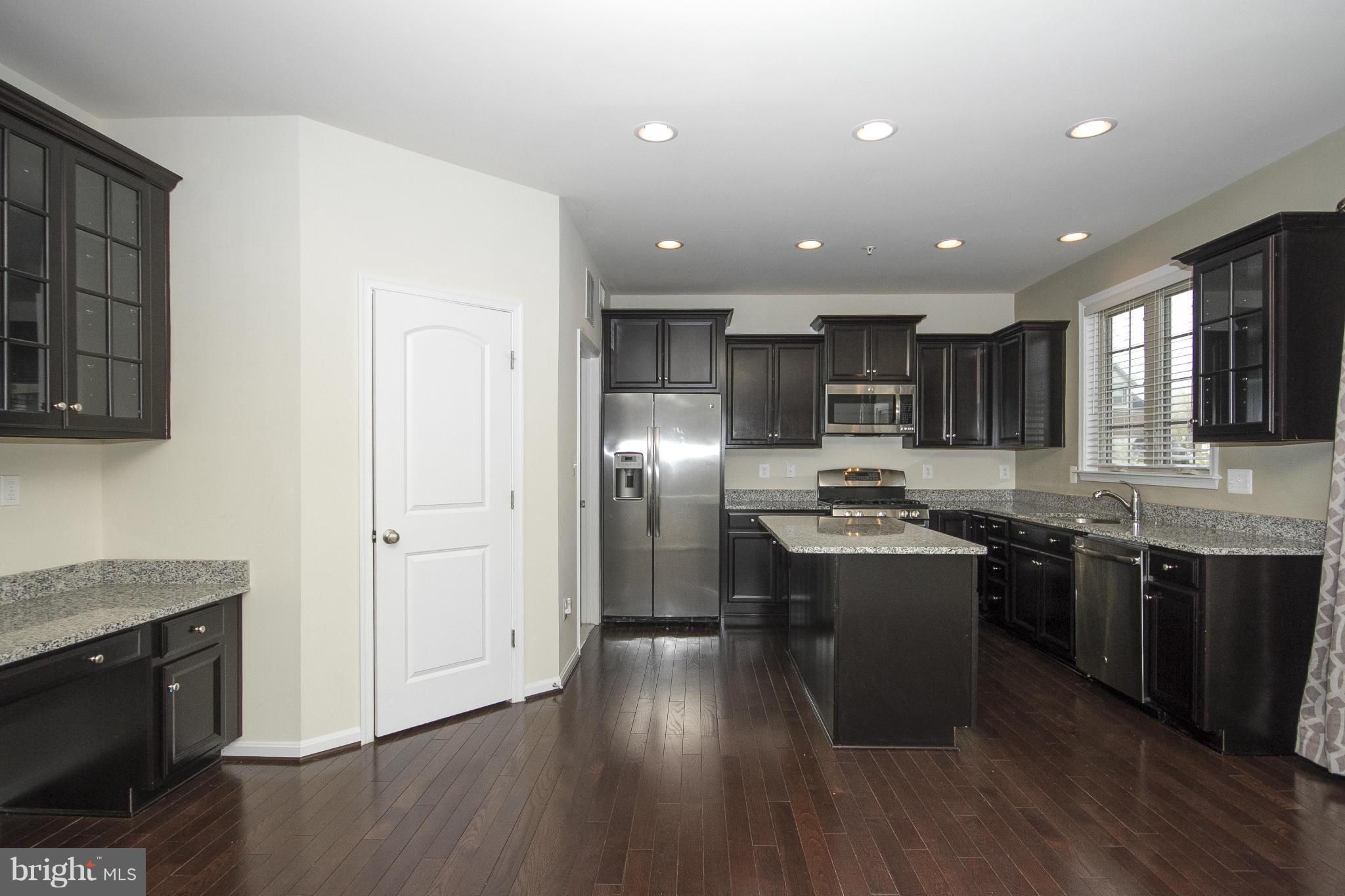 4310 Stoss Road Perry Hall, MD 21128 - Photo 9 of 22 a kitchen with stainless steel appliances granite countertop a sink stove and refrigerator