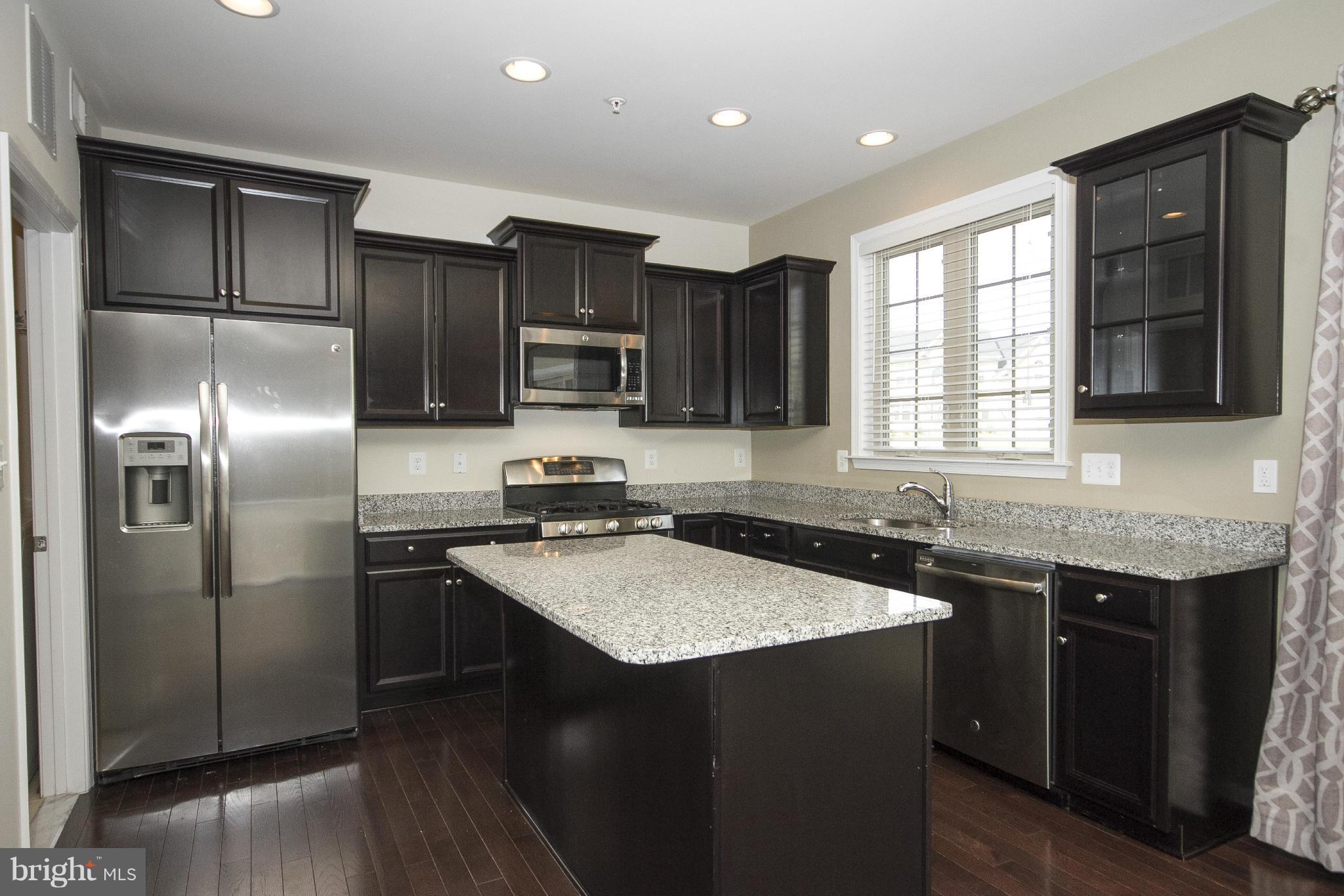 4310 Stoss Road Perry Hall, MD 21128 - Photo 10 of 22 a kitchen with a sink stove and refrigerator