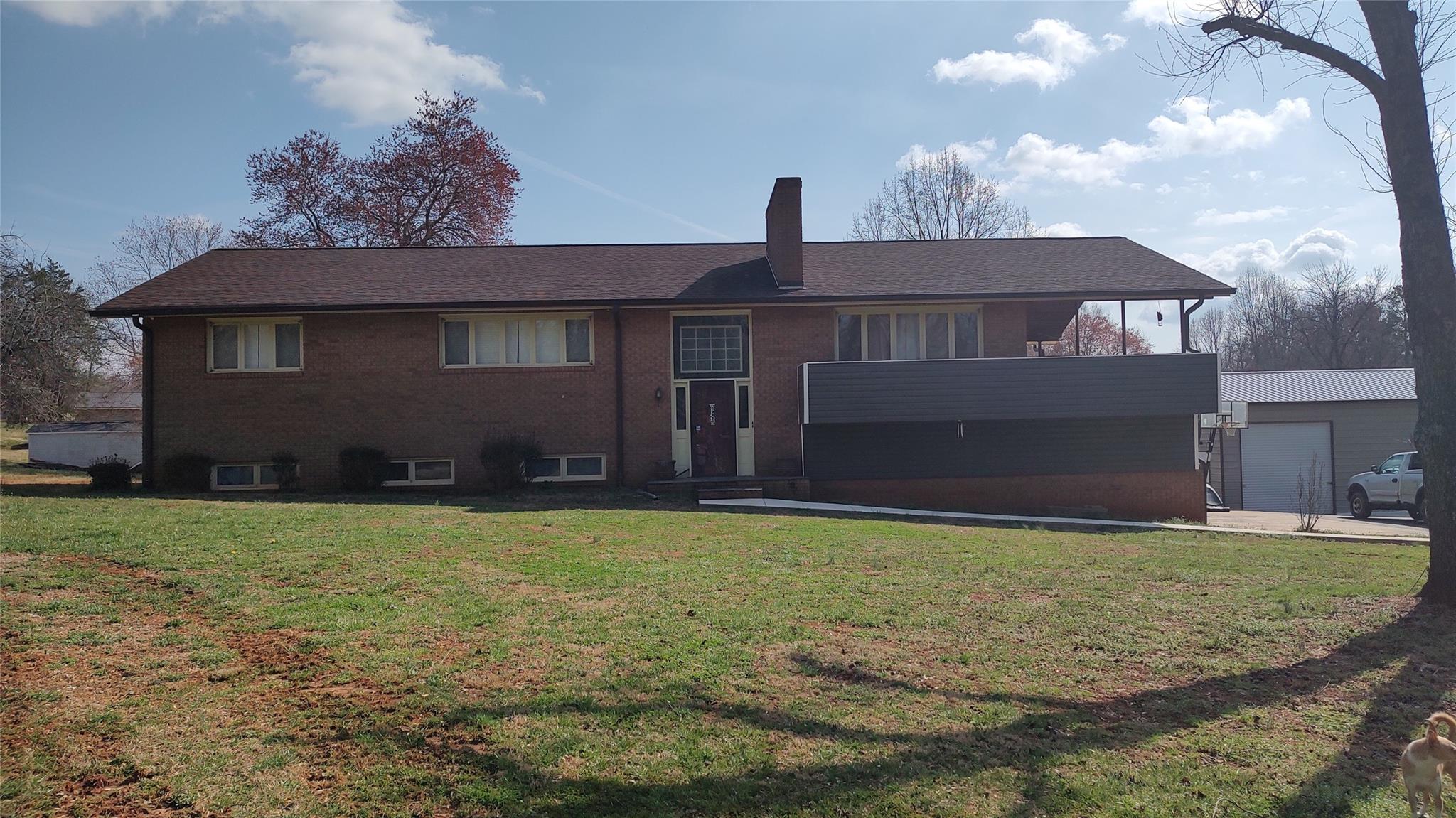 a front view of house with yard and garage