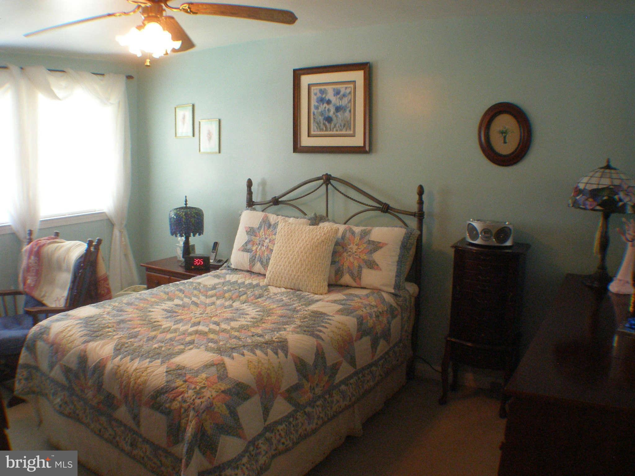 1516 Barrett Road Baltimore, MD 21207 - Photo 11 of 25 a bedroom with a bed and a chandelier