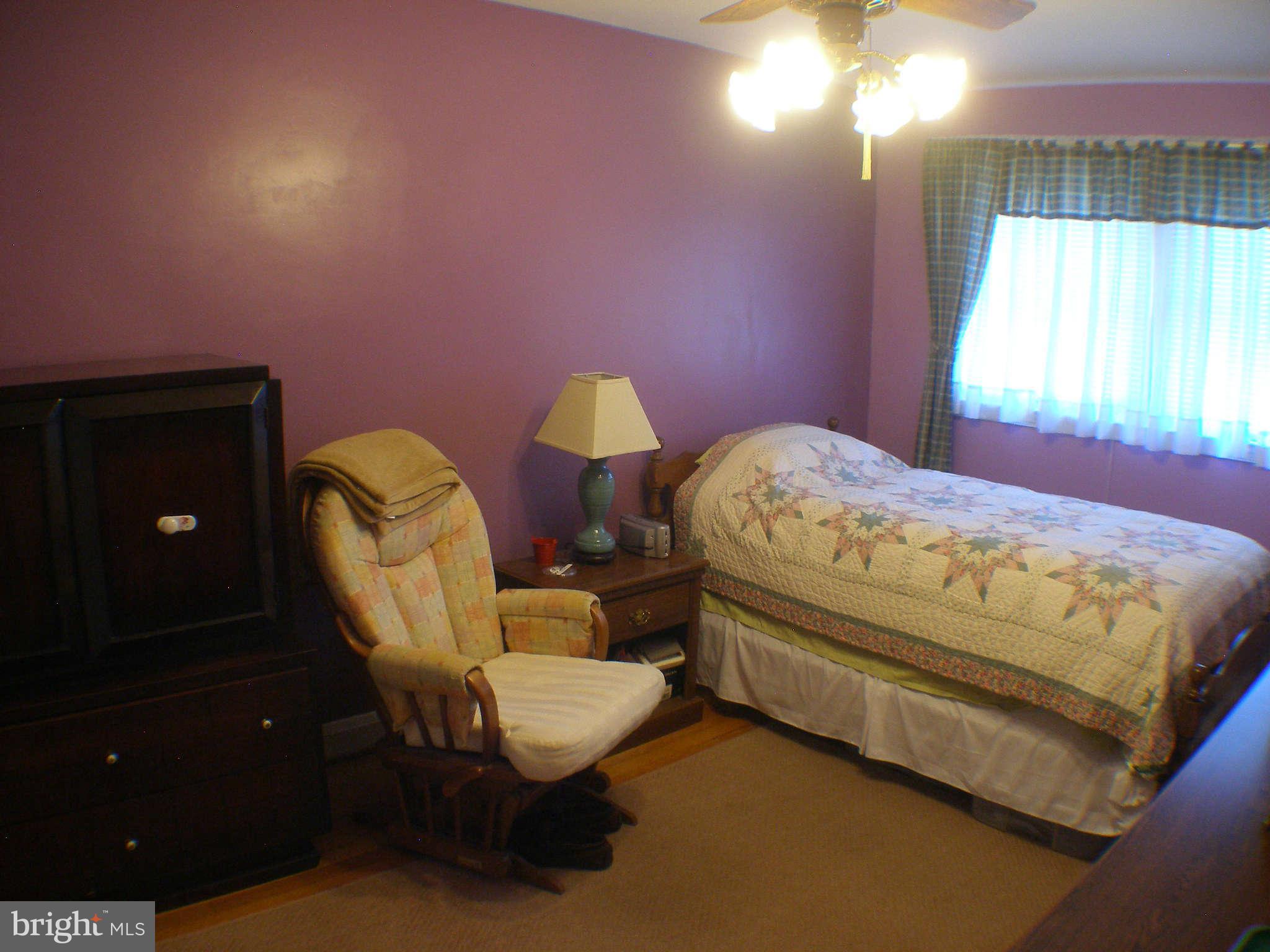 1516 Barrett Road Baltimore, MD 21207 - Photo 12 of 25 a bed room with a bed and a chandelier