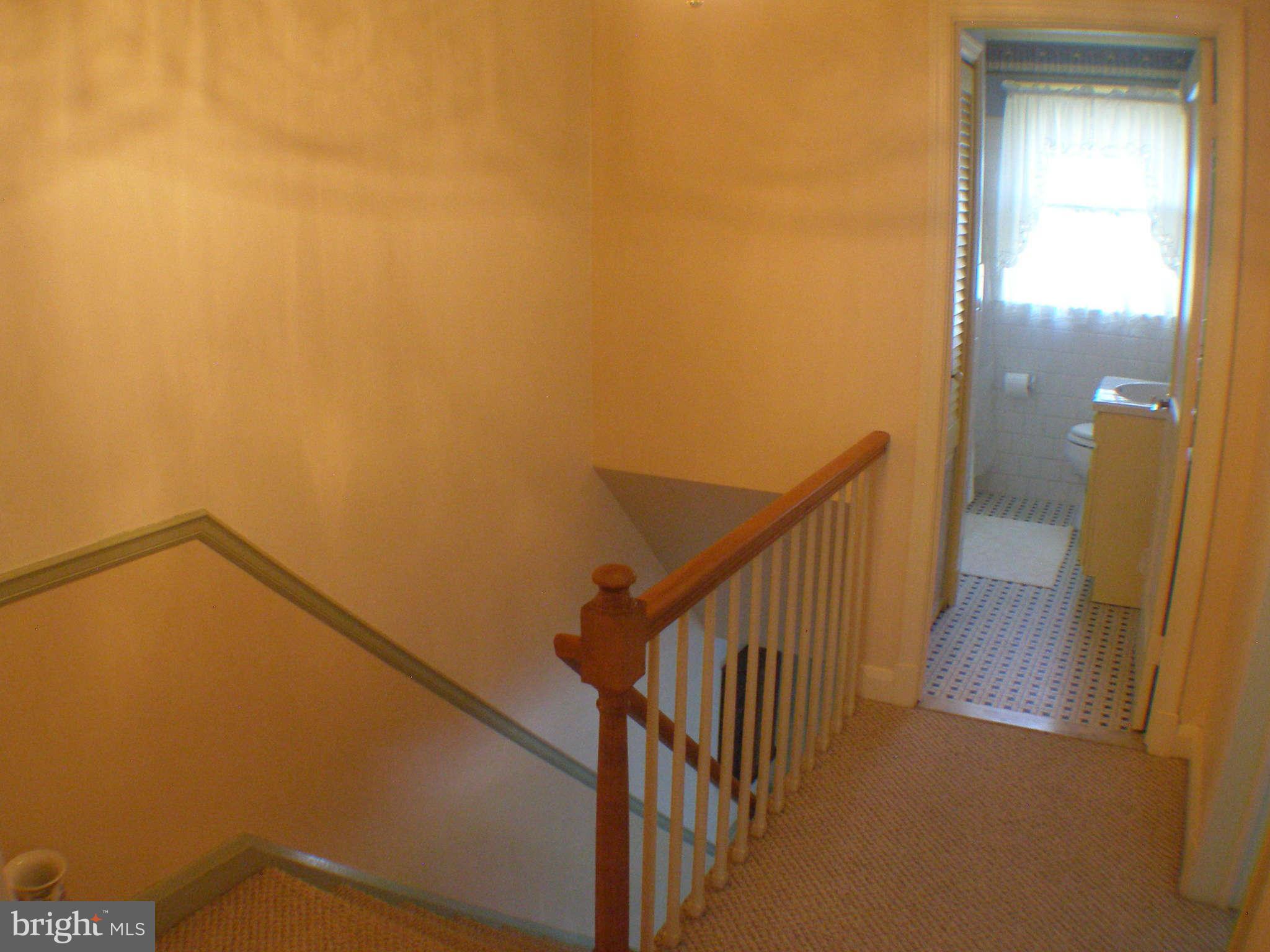 1516 Barrett Road Baltimore, MD 21207 - Photo 13 of 25 a view of a hallway with wooden floor and staircase
