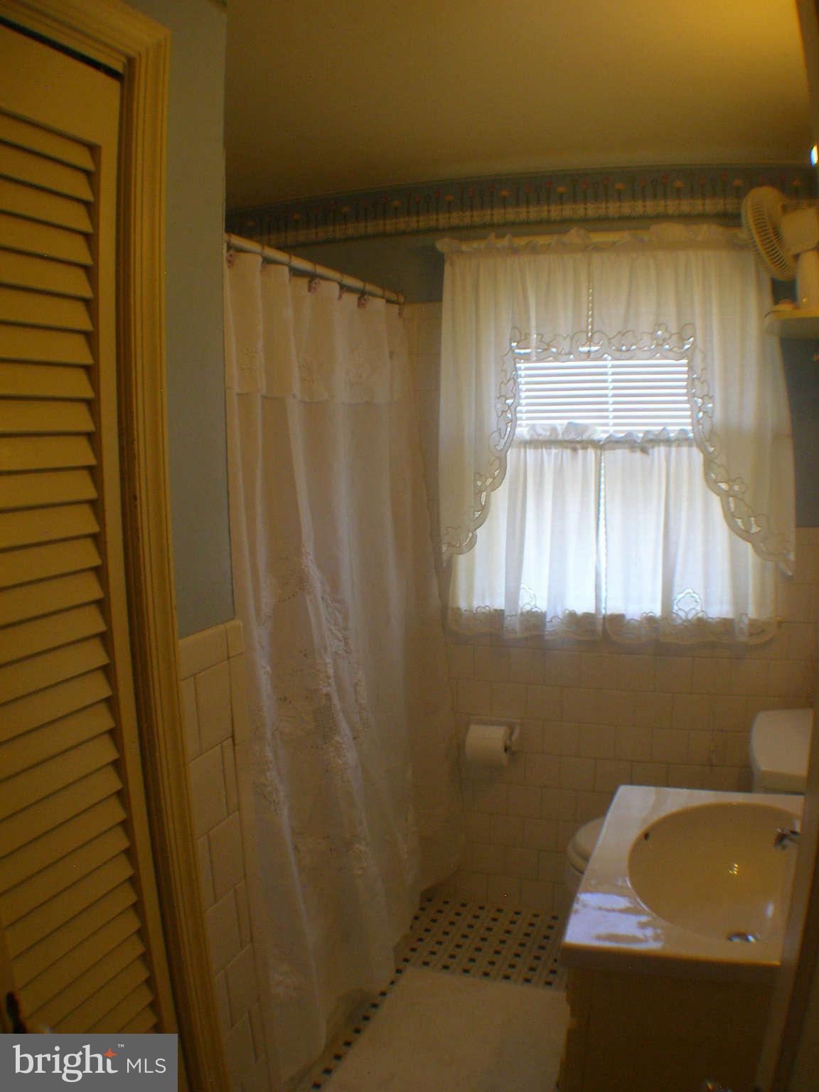 1516 Barrett Road Baltimore, MD 21207 - Photo 14 of 25 a bathroom with a sink and a shower curtain