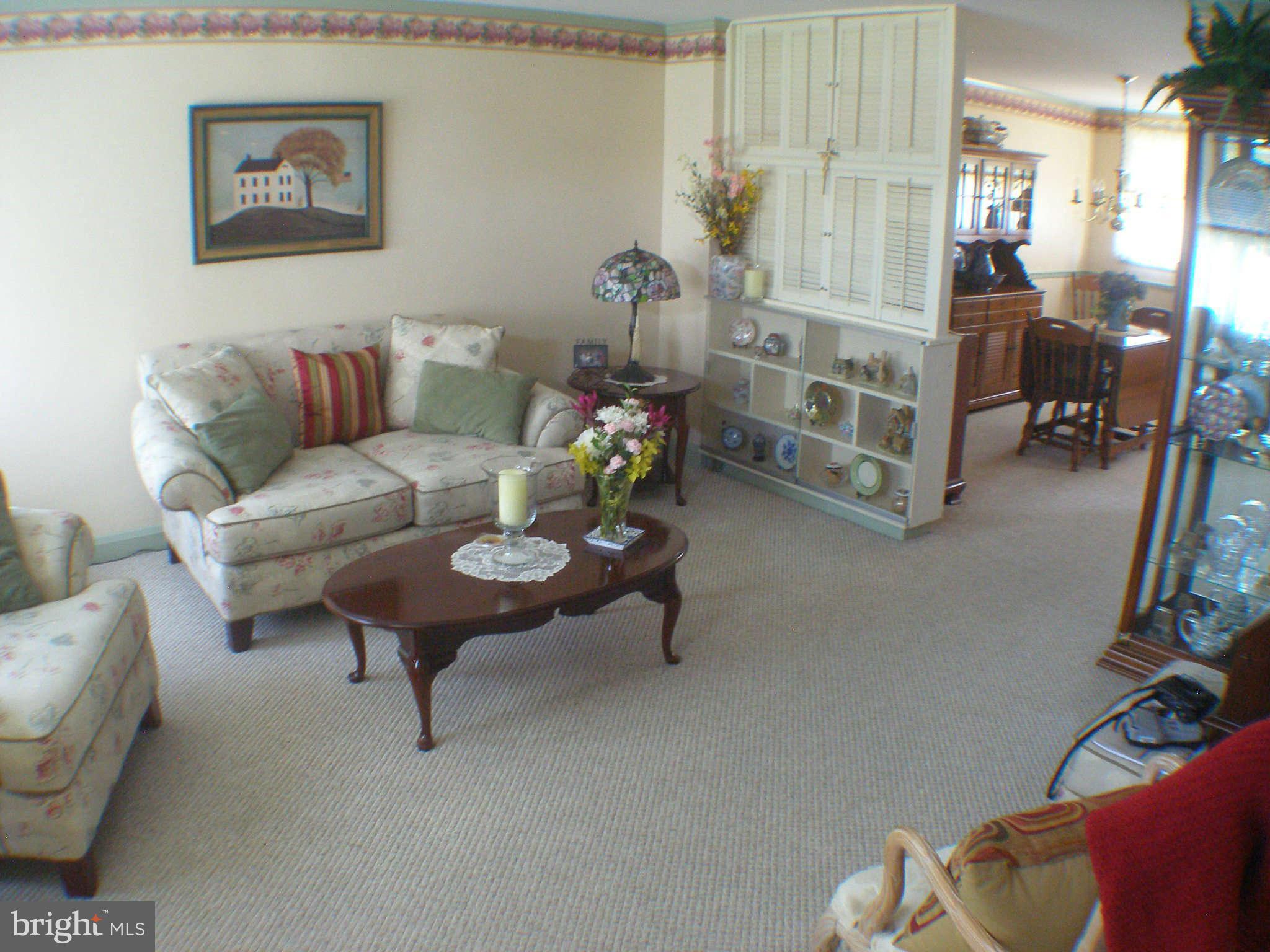 1516 Barrett Road Baltimore, MD 21207 - Photo 3 of 25 a living room with furniture and a chandelier