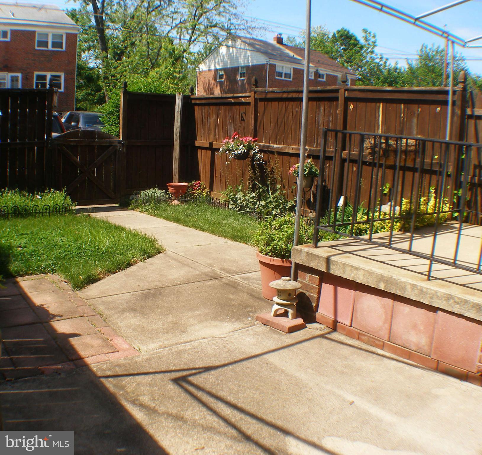 1516 Barrett Road Baltimore, MD 21207 - Photo 21 of 25 a view of a chair and table on the wooden deck