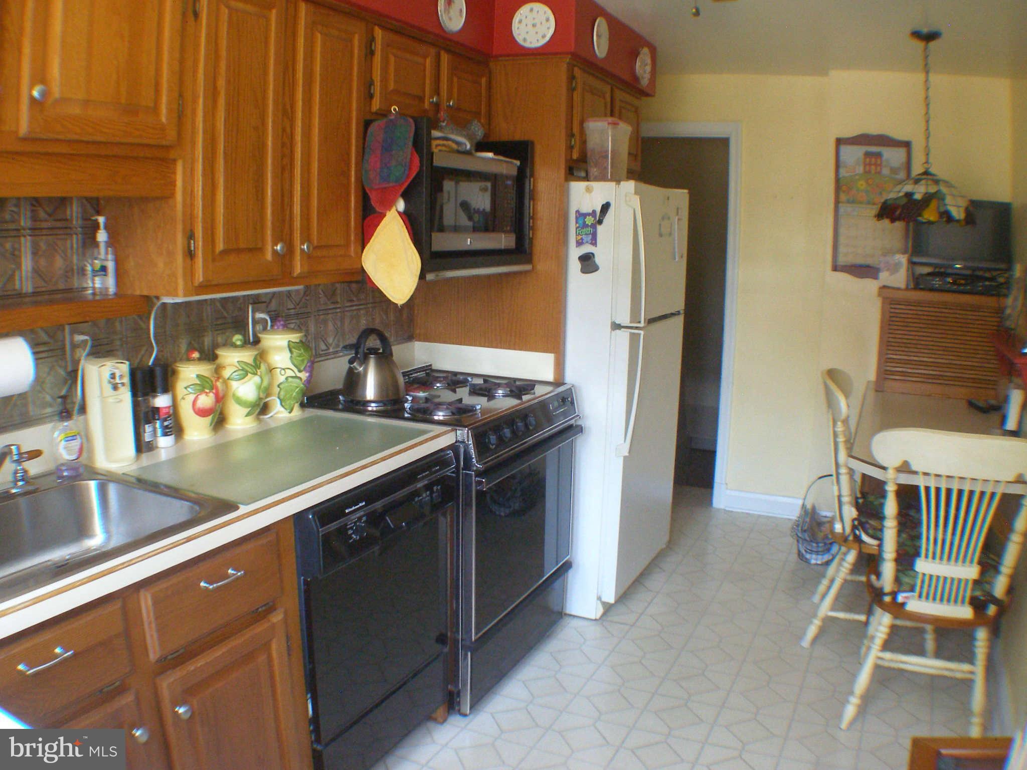 1516 Barrett Road Baltimore, MD 21207 - Photo 7 of 25 a kitchen with stainless steel appliances granite countertop a refrigerator and a stove top oven