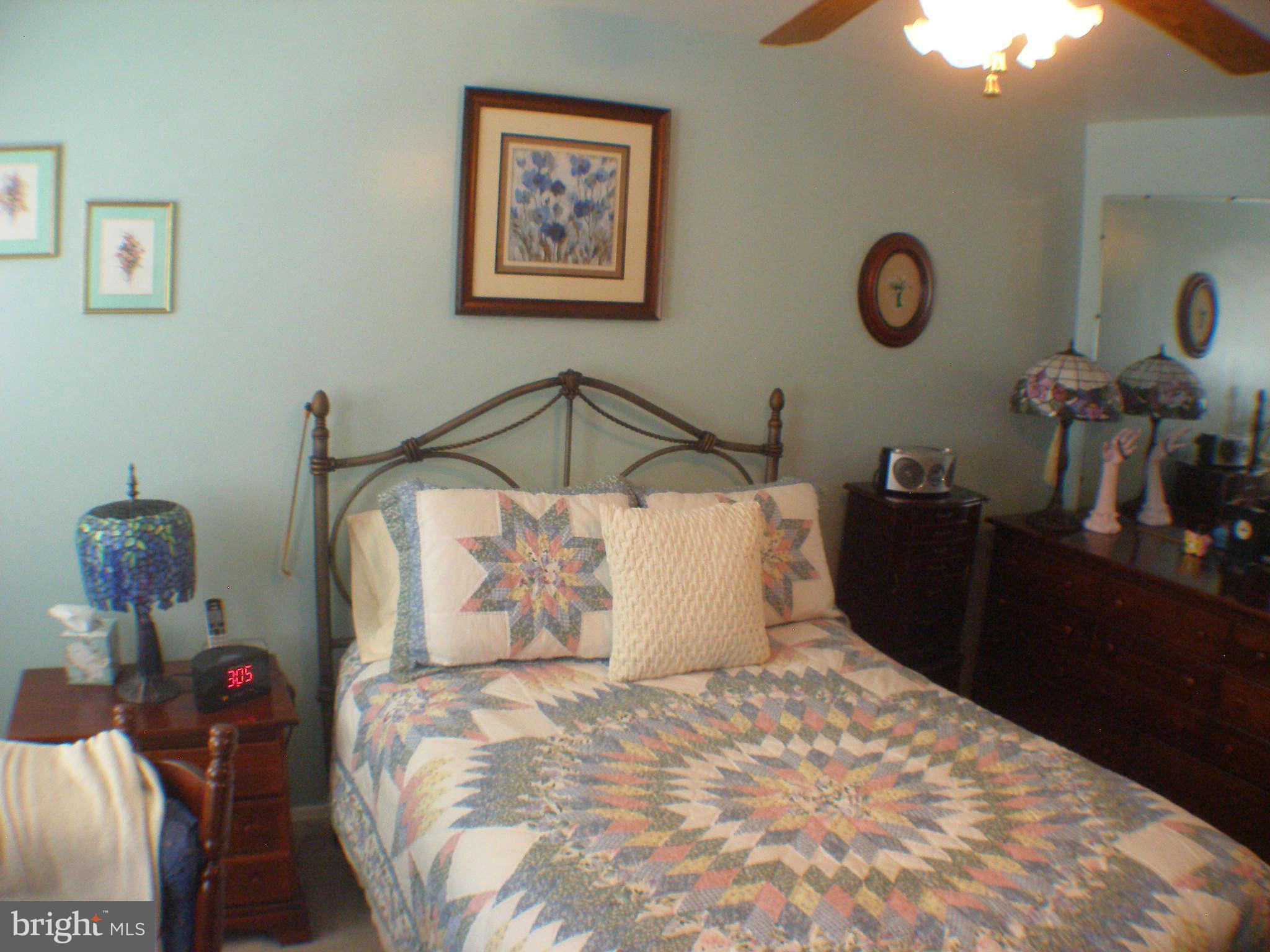 1516 Barrett Road Baltimore, MD 21207 - Photo 10 of 25 a bed sitting in a bedroom and painting on the wall