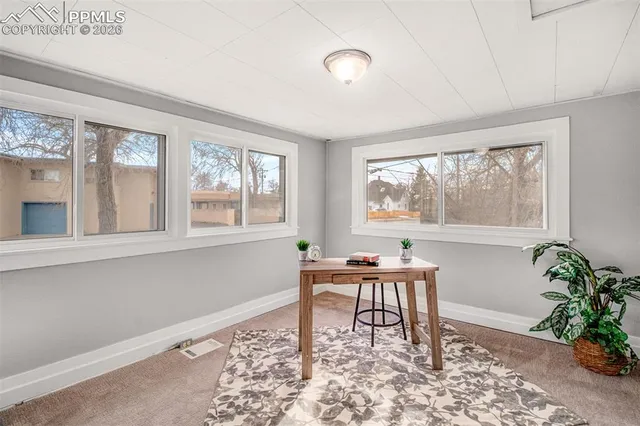 a work room with window and wooden floor