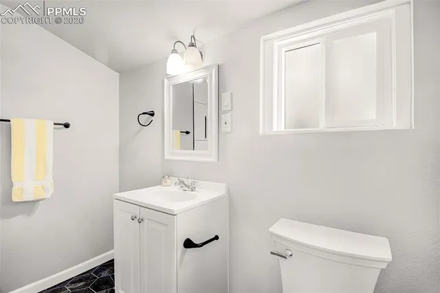 a bathroom with a sink toilet and mirror