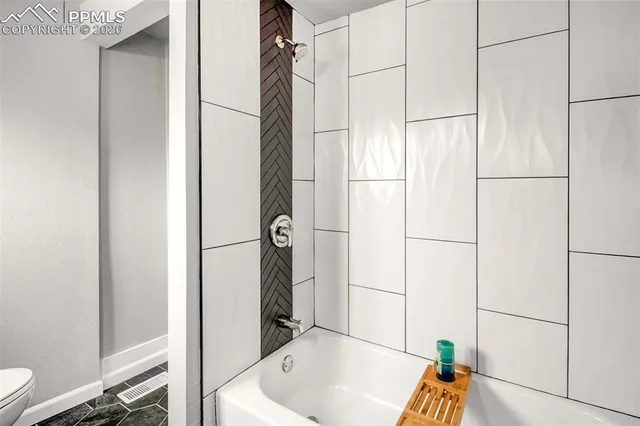a bathroom with a tub and shower