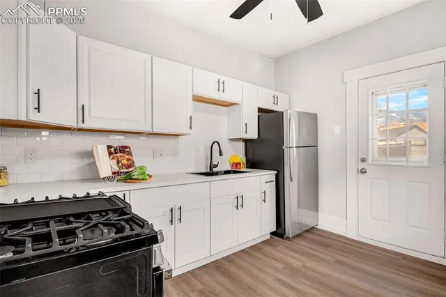 a kitchen with stainless steel appliances a stove a refrigerator and cabinets
