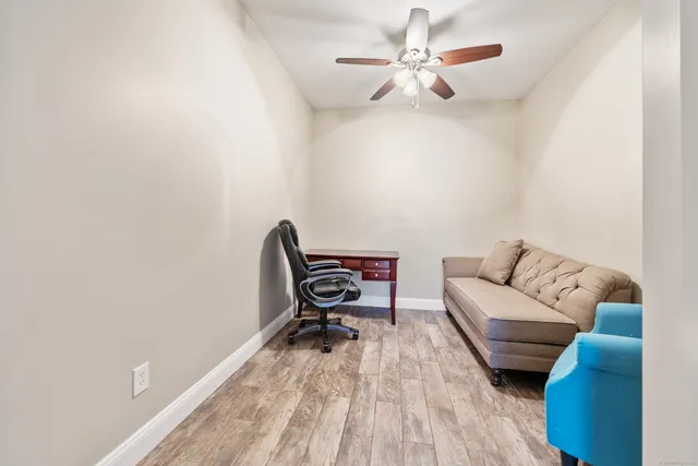a living room with furniture and a wooden floor