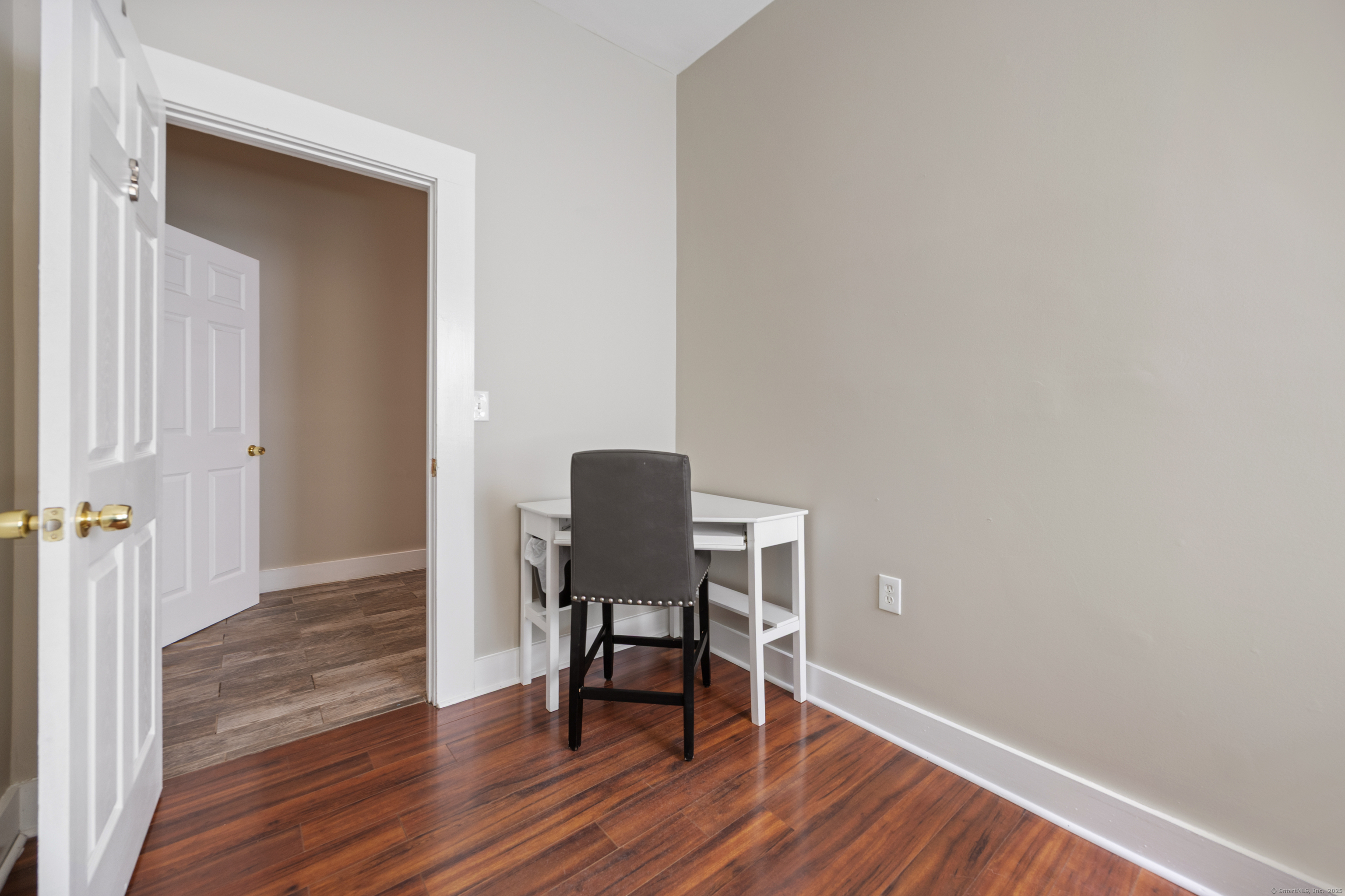 230 Frost Road Waterbury, CT 06705 - Photo 20 of 24 a view of a workspace area with wooden floor and a chair