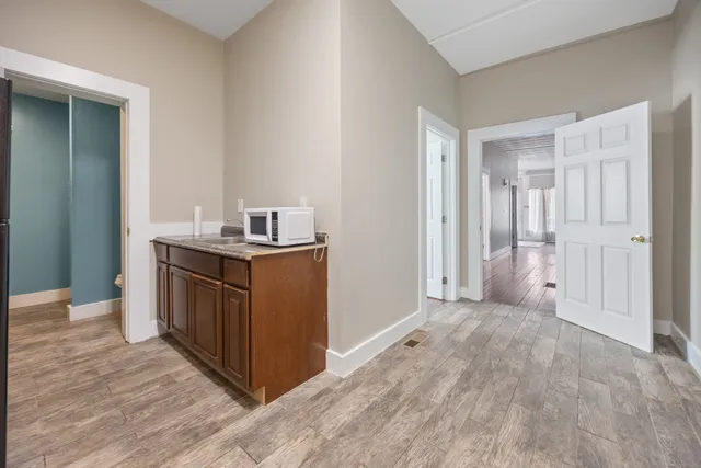 a kitchen with a wooden floor and a sink