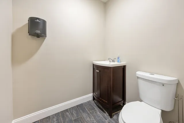 a bathroom with a sink a toilet and a mirror