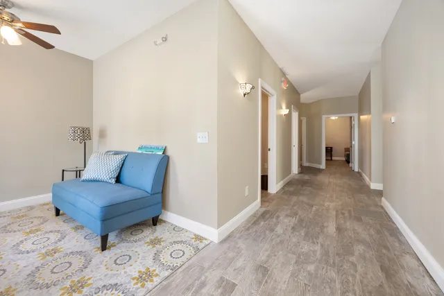 a living room with a couch and a dresser with wooden floor