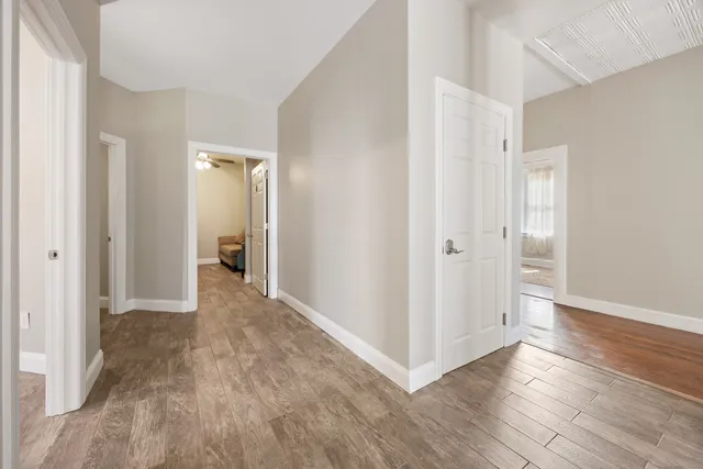 a view of a hallway with wooden floor