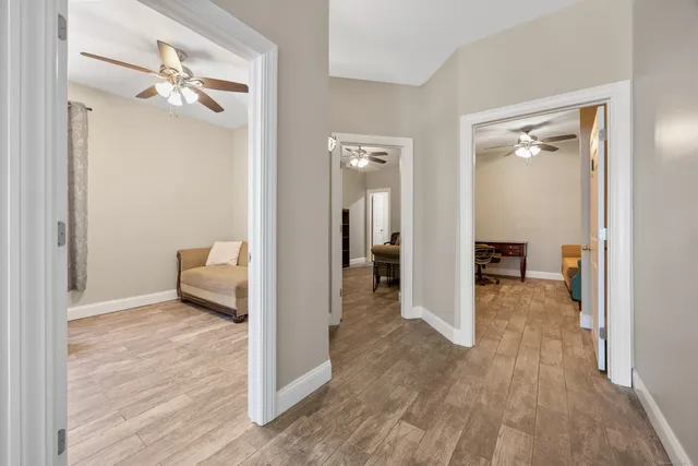 a view of a room with a hardwood floor and a bathroom
