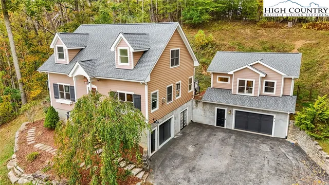 aerial view of a house with a yard