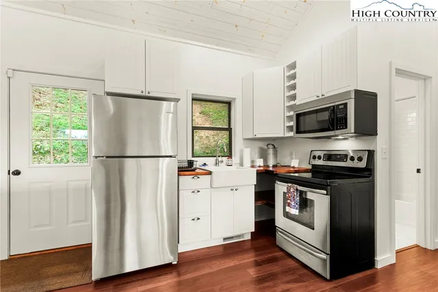 a bedroom with a large bed and a flat tv screen