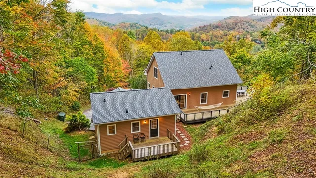 a view of a roof deck with table and chairs with wooden floor and fence