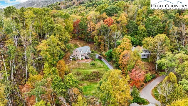 a living room with fireplace furniture and a large window